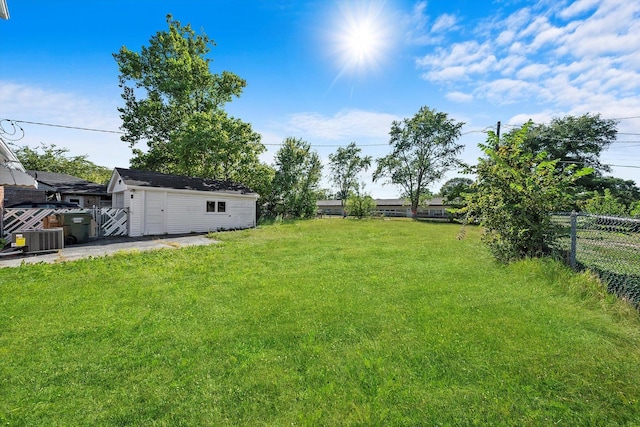 view of yard featuring central AC unit and a storage unit