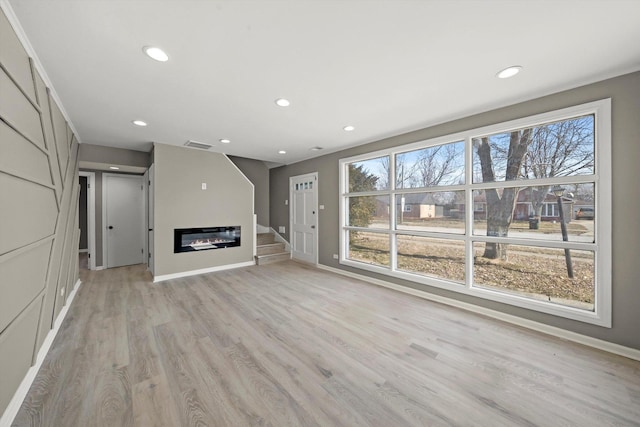 unfurnished living room with light hardwood / wood-style floors