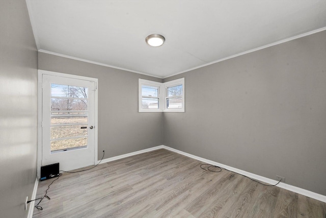 unfurnished room featuring crown molding and light hardwood / wood-style floors