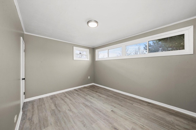 unfurnished room featuring crown molding and light hardwood / wood-style flooring