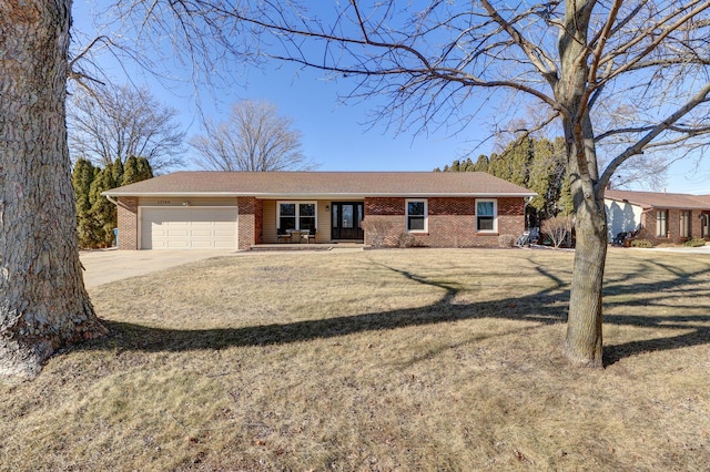 ranch-style home with a garage and a front lawn