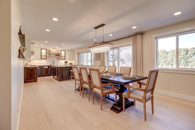 dining space featuring sink and light wood-type flooring