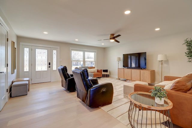 living room featuring ceiling fan and light wood-type flooring