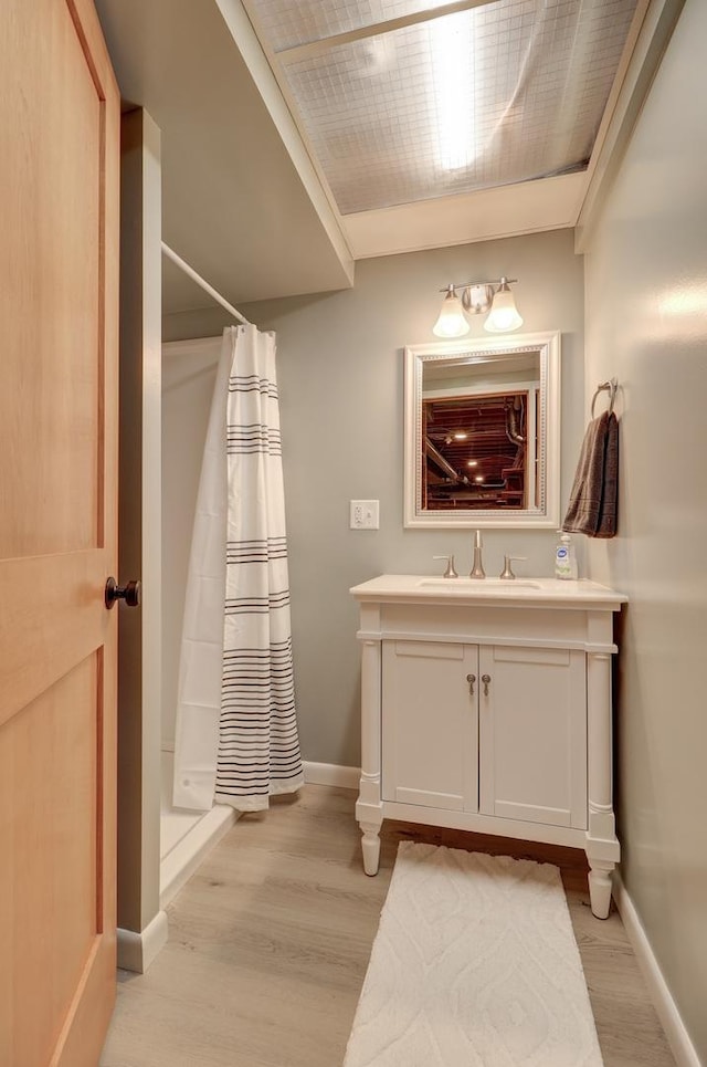 bathroom with vanity, a shower with curtain, and hardwood / wood-style flooring