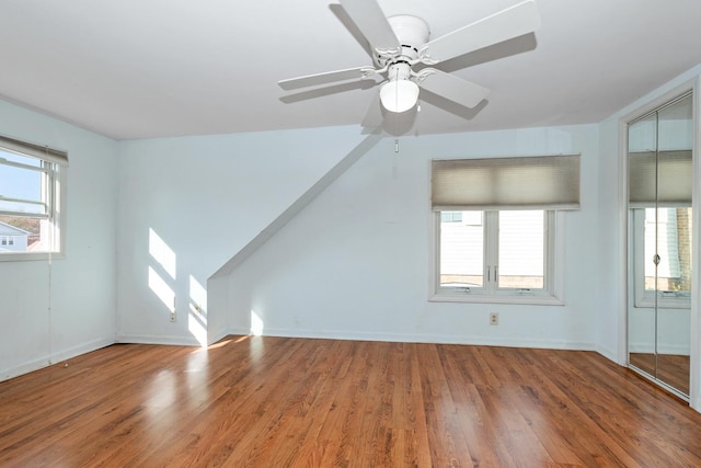 additional living space featuring wood-type flooring and ceiling fan