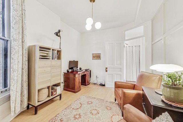 sitting room featuring light hardwood / wood-style flooring and a notable chandelier