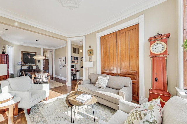 living room featuring ornamental molding and light wood-type flooring