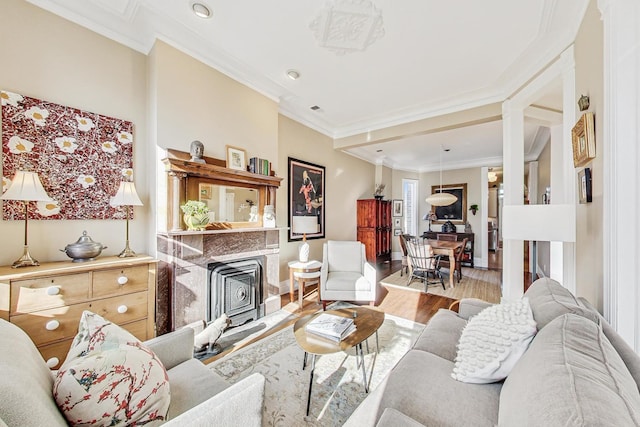 living room featuring hardwood / wood-style flooring and ornamental molding