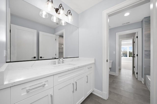 bathroom with vanity and toilet