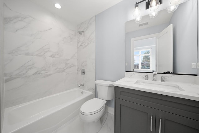 full bathroom featuring tiled shower / bath, vanity, and toilet