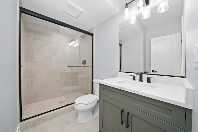 bathroom featuring tile patterned flooring, vanity, walk in shower, and toilet