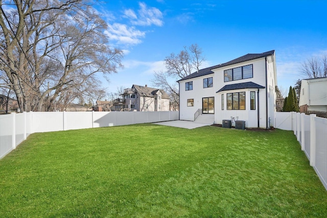 back of property featuring central AC unit, a patio area, and a lawn