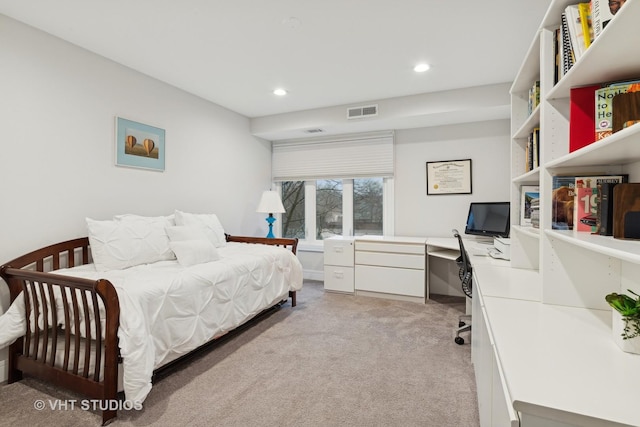 bedroom with recessed lighting, built in study area, visible vents, and light colored carpet