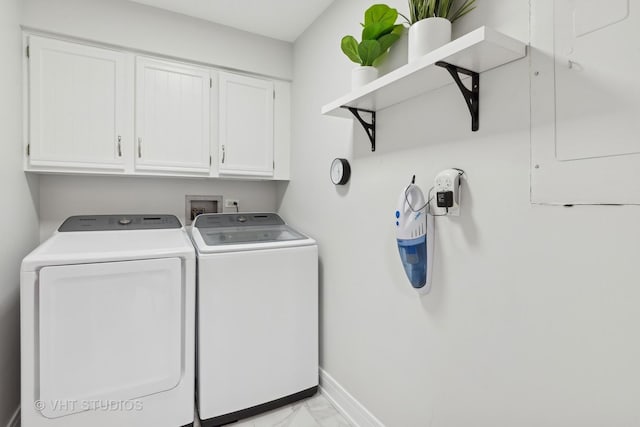 laundry room with marble finish floor, washer and clothes dryer, cabinet space, and baseboards