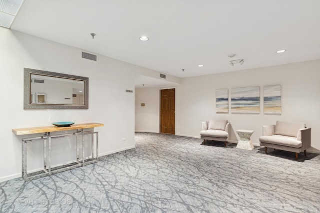 living area with carpet, visible vents, baseboards, and recessed lighting