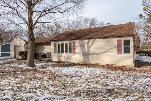 snow covered property featuring a garage