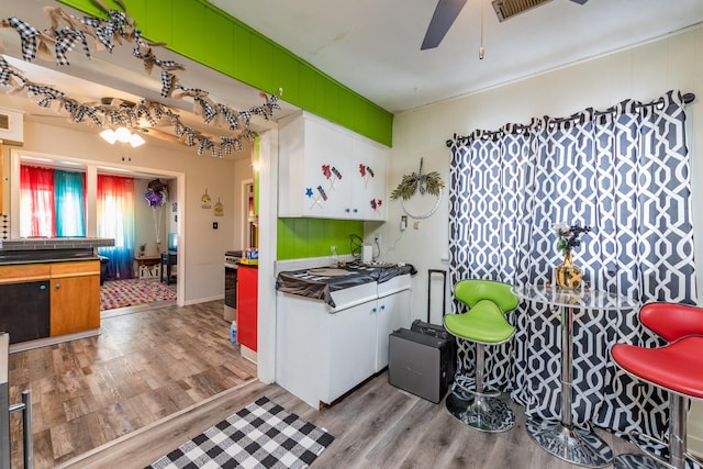 kitchen with ceiling fan and light wood-type flooring