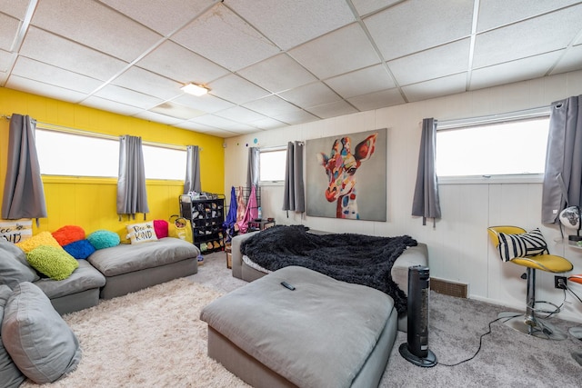 bedroom with carpet flooring and a drop ceiling