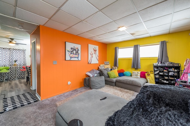 living room featuring ceiling fan, a paneled ceiling, and carpet floors