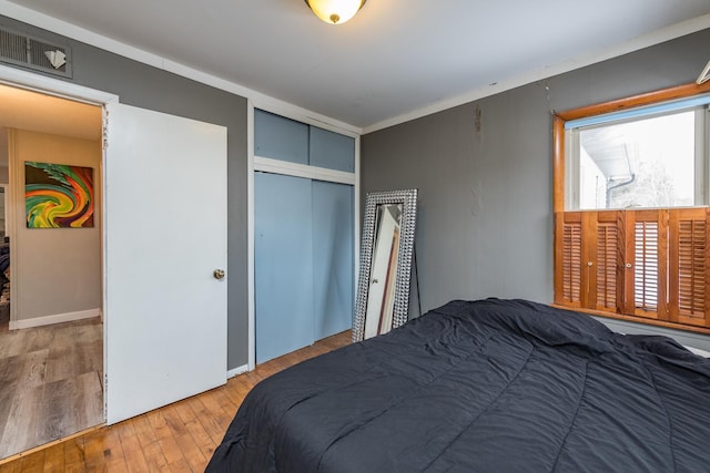 bedroom featuring hardwood / wood-style flooring and a closet