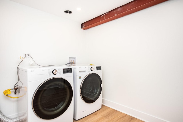 laundry room featuring hardwood / wood-style flooring and separate washer and dryer