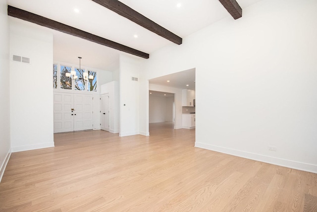 interior space featuring beam ceiling, light wood-type flooring, and a notable chandelier