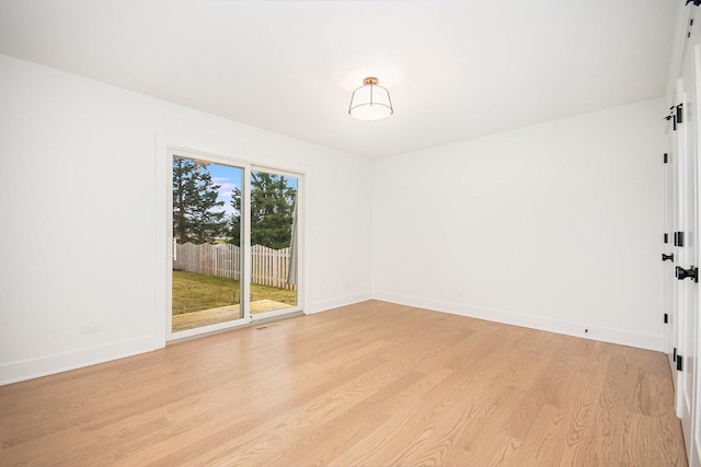 spare room with light hardwood / wood-style flooring