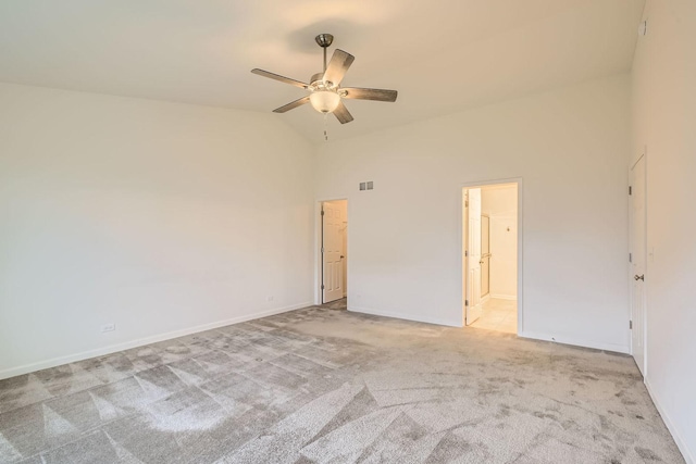 carpeted empty room featuring high vaulted ceiling and ceiling fan