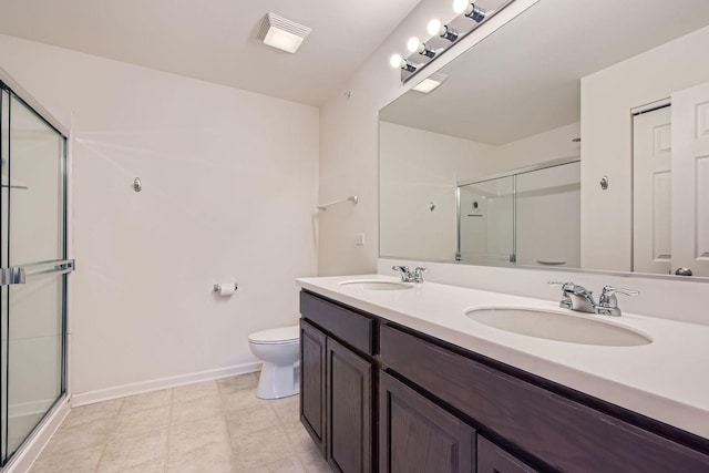 bathroom with a shower with door, vanity, and toilet