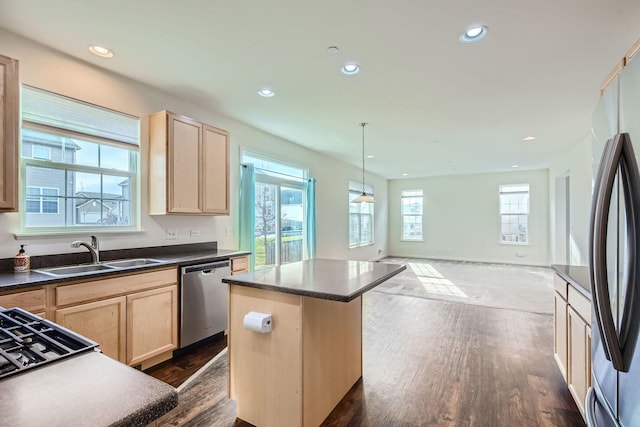 kitchen with a kitchen island, pendant lighting, sink, stainless steel appliances, and light brown cabinets