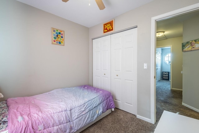 bedroom featuring ceiling fan, a closet, and dark colored carpet