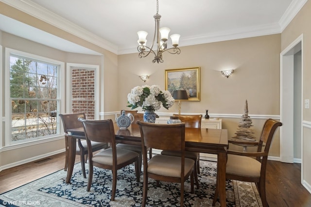 dining room featuring ornamental molding, a notable chandelier, and dark hardwood / wood-style flooring