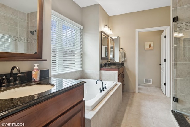 bathroom with vanity, tile patterned floors, and shower with separate bathtub