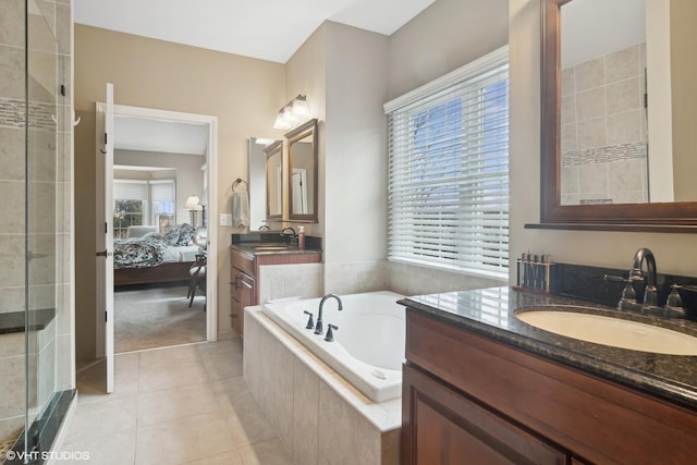 bathroom featuring vanity, shower with separate bathtub, and tile patterned floors