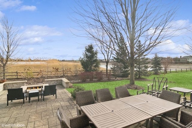 view of patio with a rural view and a fire pit