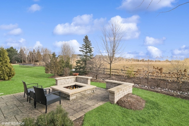 view of patio featuring a rural view and an outdoor fire pit