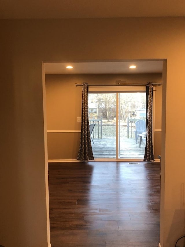 empty room with hardwood / wood-style floors