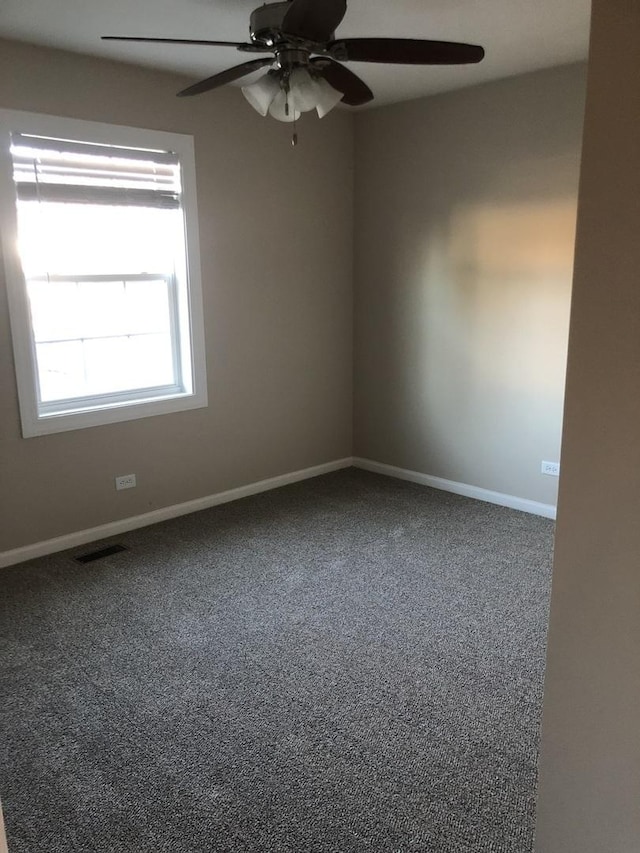 empty room with ceiling fan and carpet flooring