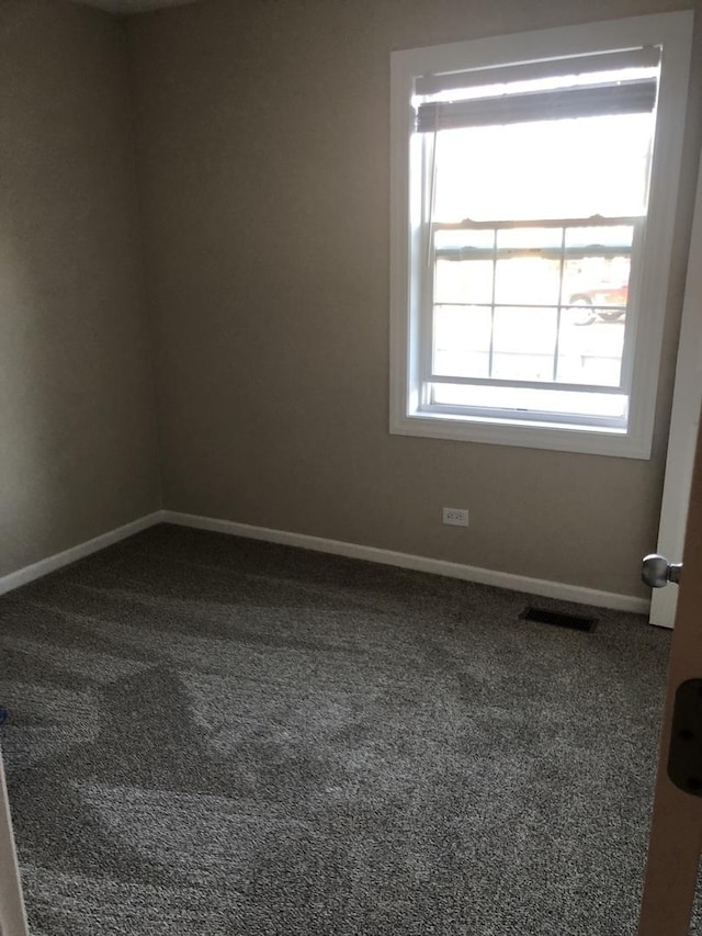 unfurnished room featuring carpet flooring