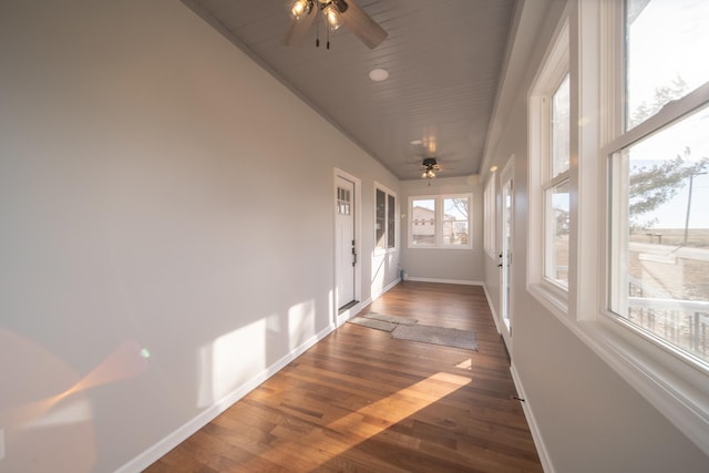 unfurnished sunroom featuring wooden ceiling and ceiling fan