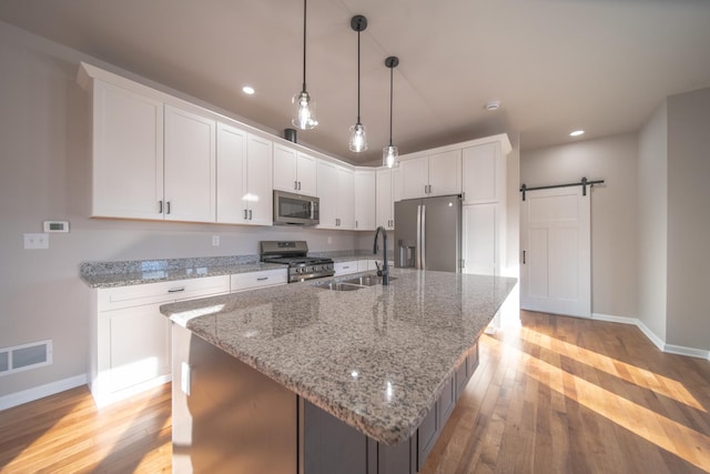 kitchen featuring sink, stainless steel appliances, and white cabinets