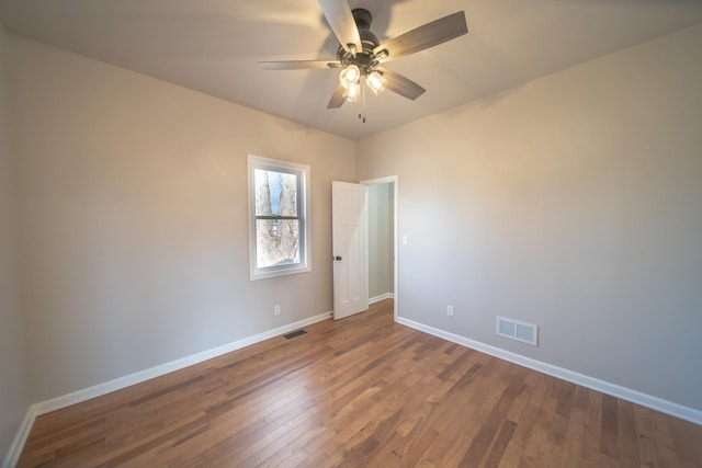 spare room with ceiling fan and hardwood / wood-style floors