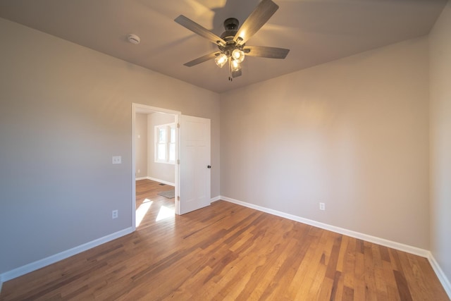 spare room with ceiling fan and wood-type flooring