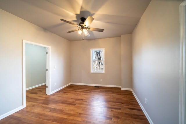 unfurnished room featuring dark hardwood / wood-style floors and ceiling fan