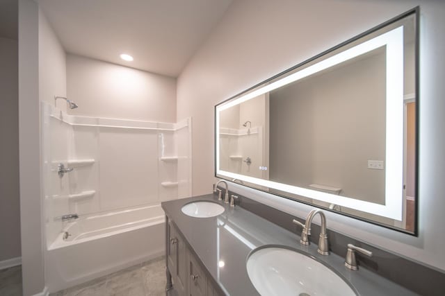 full bathroom with vanity, tile patterned floors, toilet, and washtub / shower combination