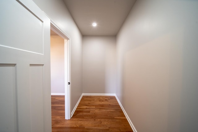 hallway with hardwood / wood-style floors