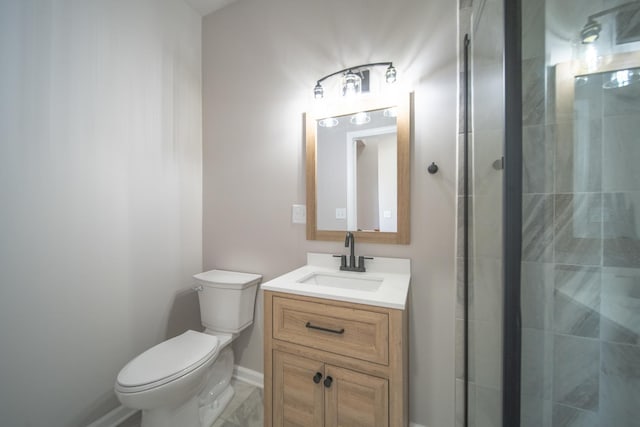 bathroom featuring vanity, toilet, and a shower with shower door