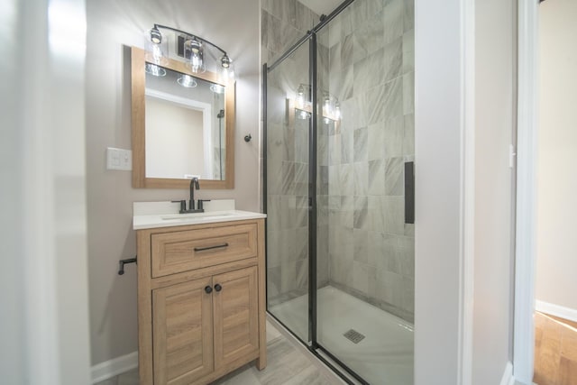 bathroom featuring vanity and an enclosed shower