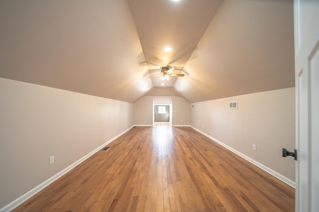 bonus room with hardwood / wood-style floors, vaulted ceiling, and ceiling fan