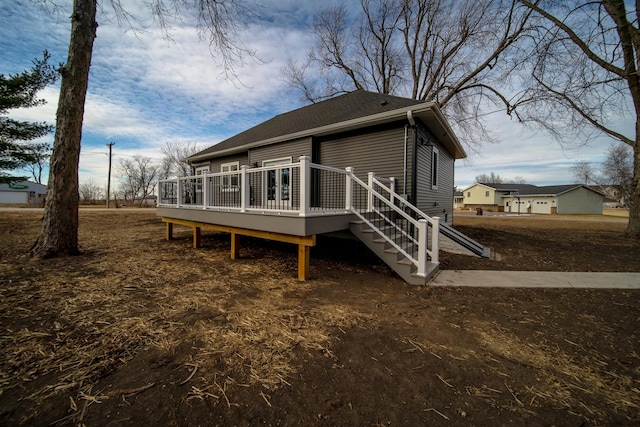 rear view of property with a wooden deck